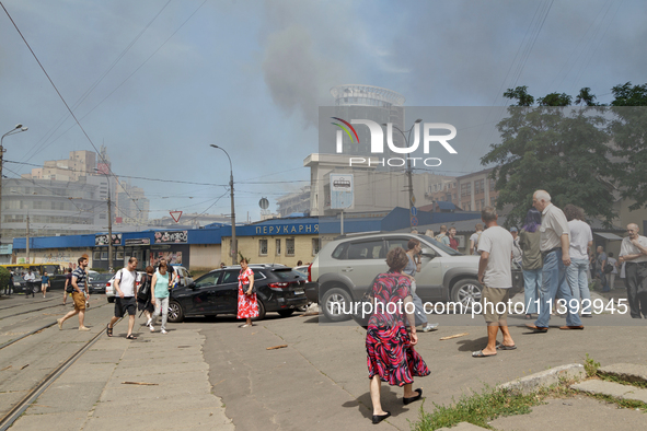 People are staying near the Lukianivska metro station as smoke is covering the surroundings as a result of a Russian missile attack in Kyiv,...