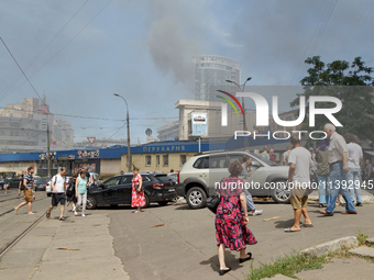 People are staying near the Lukianivska metro station as smoke is covering the surroundings as a result of a Russian missile attack in Kyiv,...