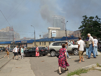 People are staying near the Lukianivska metro station as smoke is covering the surroundings as a result of a Russian missile attack in Kyiv,...