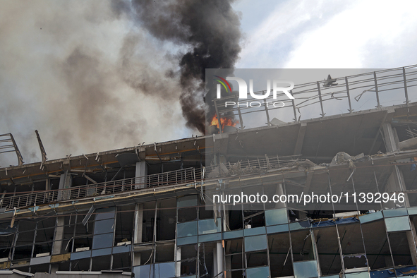 The roof of an unfinished building is catching fire near the Lukianivska metro station as a result of a Russian missile attack in Kyiv, Ukra...