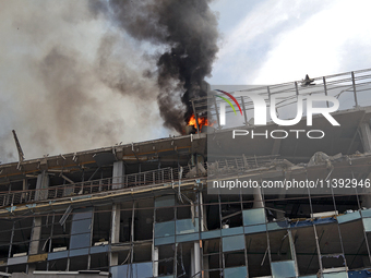 The roof of an unfinished building is catching fire near the Lukianivska metro station as a result of a Russian missile attack in Kyiv, Ukra...