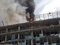 The roof of an unfinished building is catching fire near the Lukianivska metro station as a result of a Russian missile attack in Kyiv, Ukra...