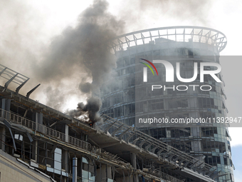 The roof of an unfinished building is catching fire near the Lukianivska metro station as a result of a Russian missile attack in Kyiv, Ukra...