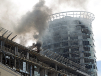 The roof of an unfinished building is catching fire near the Lukianivska metro station as a result of a Russian missile attack in Kyiv, Ukra...