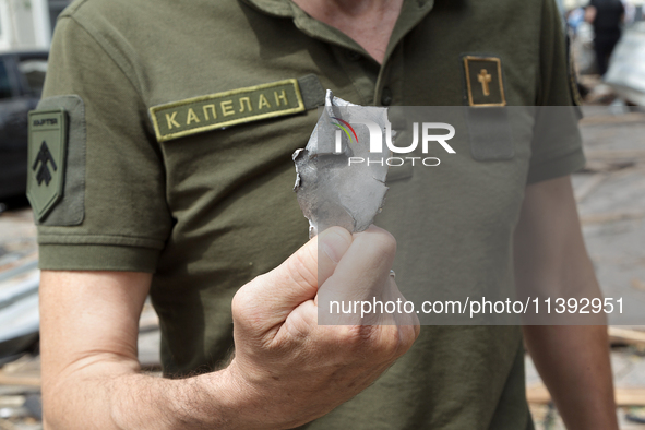 A chaplain is showing a piece of a Russian missile found near the Lukianivska metro station in Kyiv, Ukraine, on July 8, 2024. NO USE RUSSIA...