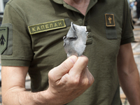 A chaplain is showing a piece of a Russian missile found near the Lukianivska metro station in Kyiv, Ukraine, on July 8, 2024. NO USE RUSSIA...