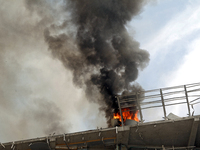 The roof of an unfinished building is catching fire near the Lukianivska metro station as a result of a Russian missile attack in Kyiv, Ukra...