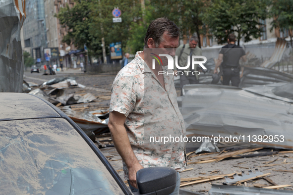 A man is standing by a car parked near the Lukianivska metro station during a Russian missile attack in Kyiv, Ukraine, on July 8, 2024. NO U...