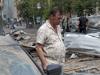 A man is standing by a car parked near the Lukianivska metro station during a Russian missile attack in Kyiv, Ukraine, on July 8, 2024. NO U...