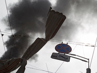 A piece of debris is hanging on the overhead line used by trolleybuses near the Lukianivska metro station during a Russian missile attack in...