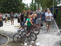 People are staying outside a building in the Solomianskyi district destroyed by a Russian missile strike in Kyiv, Ukraine, on July 8, 2024....