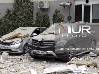 Cars are being crushed by the rubble and are parked at an office building in the Solomianskyi district damaged by a Russian missile strike i...