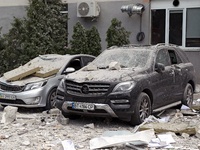 Cars are being crushed by the rubble and are parked at an office building in the Solomianskyi district damaged by a Russian missile strike i...