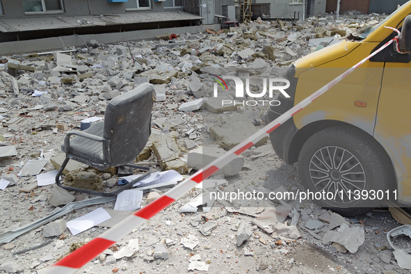 An office chair is among the rubble covering the ground at a business building in the Solomianskyi district damaged by a Russian missile str...