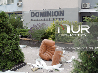 An armchair is lying outside an office building in the Solomianskyi district during a response effort to a Russian missile strike in Kyiv, U...