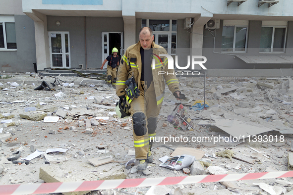 Rescue workers are at a building in the Solomianskyi district damaged by a Russian missile strike in Kyiv, Ukraine, on July 8, 2024. NO USE...