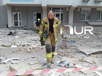 Rescue workers are at a building in the Solomianskyi district damaged by a Russian missile strike in Kyiv, Ukraine, on July 8, 2024. NO USE...