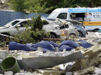 Cars are being crushed by the rubble and are parked at an office building in the Solomianskyi district damaged by a Russian missile strike i...