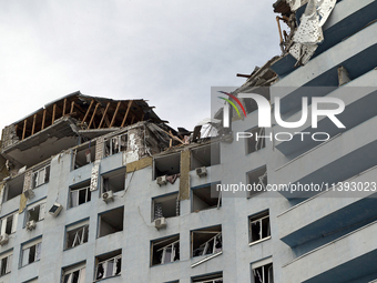 The top floors of an office building at 40 Ushynskoho Street in the Solomianskyi district are being destroyed by a Russian missile strike in...