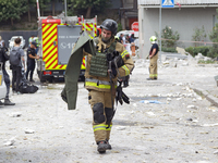 A rescue worker is responding to a Russian missile strike in the Solomianskyi district in Kyiv, Ukraine, on July 8, 2024. (