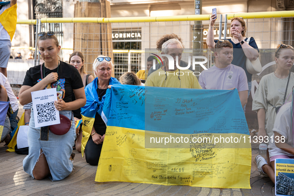 Ukrainian community protest against the Russian shelling of Ohmatdyt Children's Hospital in Kyiv, Ukraine, in Barcelona, Spain, on July 8, 2...