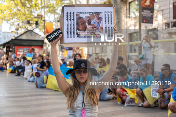 Ukrainian community protest against the Russian shelling of Ohmatdyt Children's Hospital in Kyiv, Ukraine, in Barcelona, Spain, on July 8, 2...