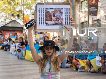 Ukrainian community protest against the Russian shelling of Ohmatdyt Children's Hospital in Kyiv, Ukraine, in Barcelona, Spain, on July 8, 2...