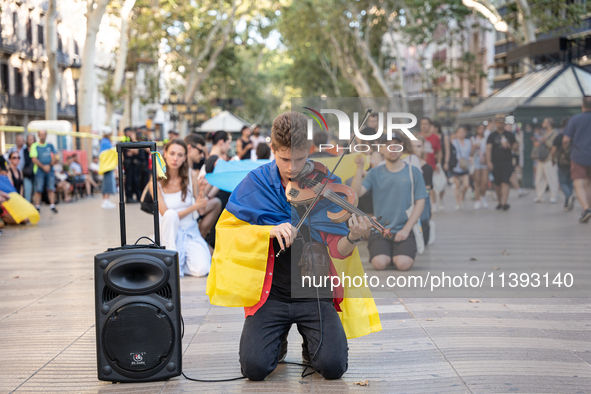 Ukrainian community protest against the Russian shelling of Ohmatdyt Children's Hospital in Kyiv, Ukraine, in Barcelona, Spain, on July 8, 2...