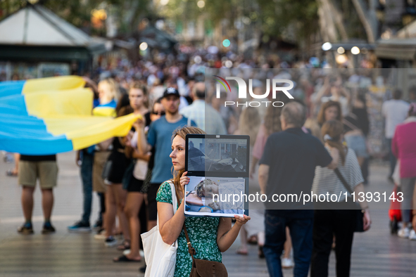 Ukrainian community protest against the Russian shelling of Ohmatdyt Children's Hospital in Kyiv, Ukraine, in Barcelona, Spain, on July 8, 2...