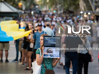 Ukrainian community protest against the Russian shelling of Ohmatdyt Children's Hospital in Kyiv, Ukraine, in Barcelona, Spain, on July 8, 2...