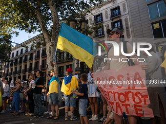 Ukrainian community protest against the Russian shelling of Ohmatdyt Children's Hospital in Kyiv, Ukraine, in Barcelona, Spain, on July 8, 2...