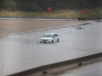 A single car is being seen abandoned on a flooded I10 at Washington St. in Houston, Texas, on July 8, 2024. (