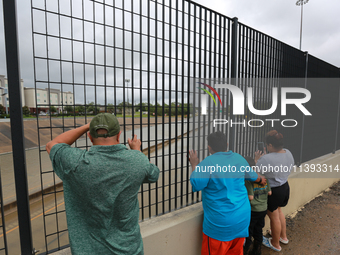 Spectators are taking pictures and videos of the flooding on I10 at Washington St. in Houston, Texas, on July 8, 2024. (