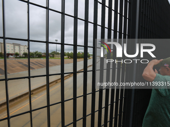 Spectators are taking pictures and videos of the flooding on I10 at Washington St. in Houston, Texas, on July 8, 2024. (