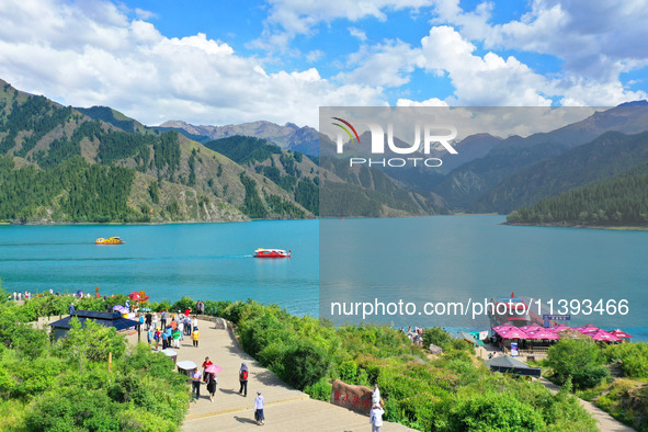 Tourists are visiting the Tianchi Scenic spot in Fukang, China, on July 8, 2024. 