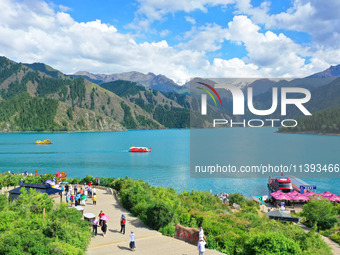 Tourists are visiting the Tianchi Scenic spot in Fukang, China, on July 8, 2024. (