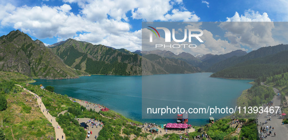 Tourists are visiting the Tianchi Scenic spot in Fukang, China, on July 8, 2024. 