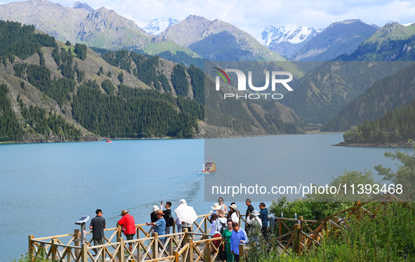 Tourists are visiting the Tianchi Scenic spot in Fukang, China, on July 8, 2024. 