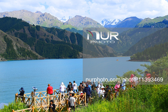 Tourists are visiting the Tianchi Scenic spot in Fukang, China, on July 8, 2024. 