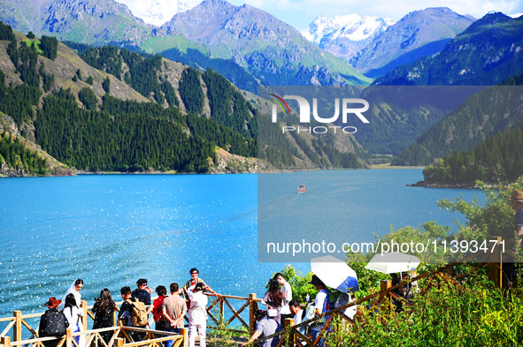 Tourists are visiting the Tianchi Scenic spot in Fukang, China, on July 8, 2024. 