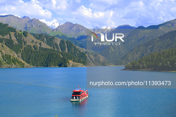 Tourists are visiting the Tianchi Scenic spot in Fukang, China, on July 8, 2024. 