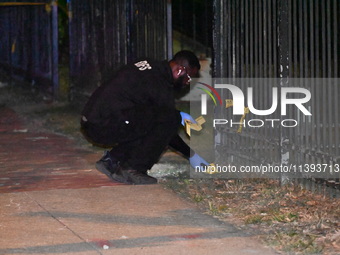 Evidence markers are being placed at the crime scene. A mass shooting is injuring four people in Washington, D.C., United States, on July 8,...