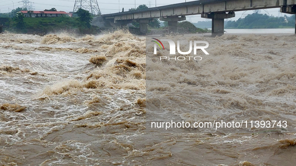 Water levels are rising in the Mahananda River and the Teesta Canal Fulbari near Siliguri, India, on July 9, 2024, due to heavy rainfall in...