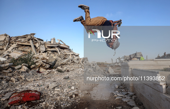 Palestinian youths are playing parkour at the ruins of a building destroyed in recent Israeli air strikes, in Zawayda, in the central Gaza S...