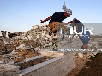 Palestinian youths are playing parkour at the ruins of a building destroyed in recent Israeli air strikes, in Zawayda, in the central Gaza S...