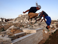 Palestinian youths are playing parkour at the ruins of a building destroyed in recent Israeli air strikes, in Zawayda, in the central Gaza S...