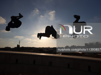 Palestinian youths are playing parkour at the ruins of a building destroyed in recent Israeli air strikes, in Zawayda, in the central Gaza S...