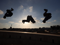 Palestinian youths are playing parkour at the ruins of a building destroyed in recent Israeli air strikes, in Zawayda, in the central Gaza S...