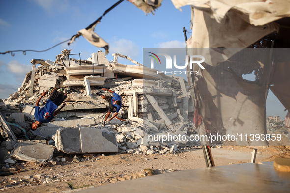 Palestinian youths are playing parkour at the ruins of a building destroyed in recent Israeli air strikes, in Zawayda, in the central Gaza S...