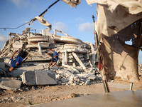 Palestinian youths are playing parkour at the ruins of a building destroyed in recent Israeli air strikes, in Zawayda, in the central Gaza S...